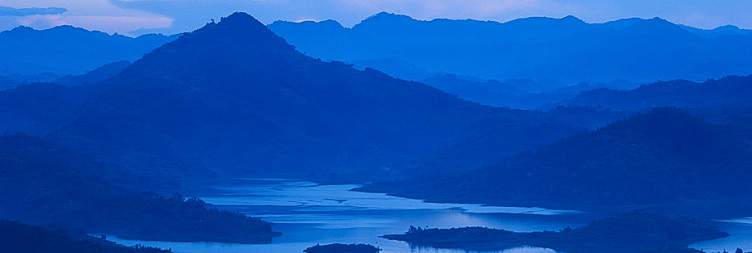 Transfer to Rwanda - Volcanoes National Park for Golden monkey tekking , scenic cross - border drive